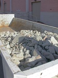 Concrete rubble in a dumpster outside the Villa Theatre